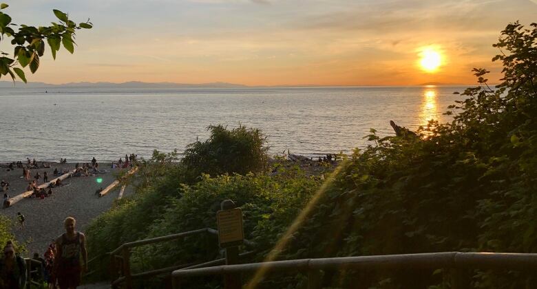 Beachgoers enjoy the sunset at Wreck Beach in Vancouver.