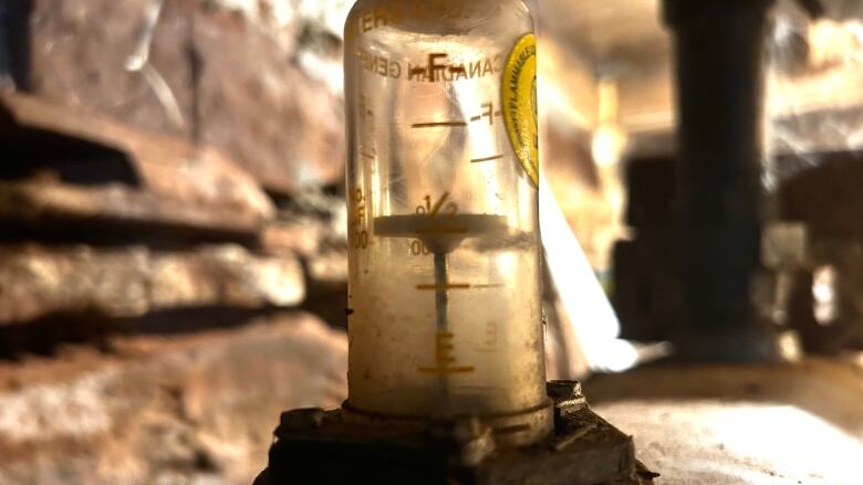 A gauge on top of a heating oil tank.