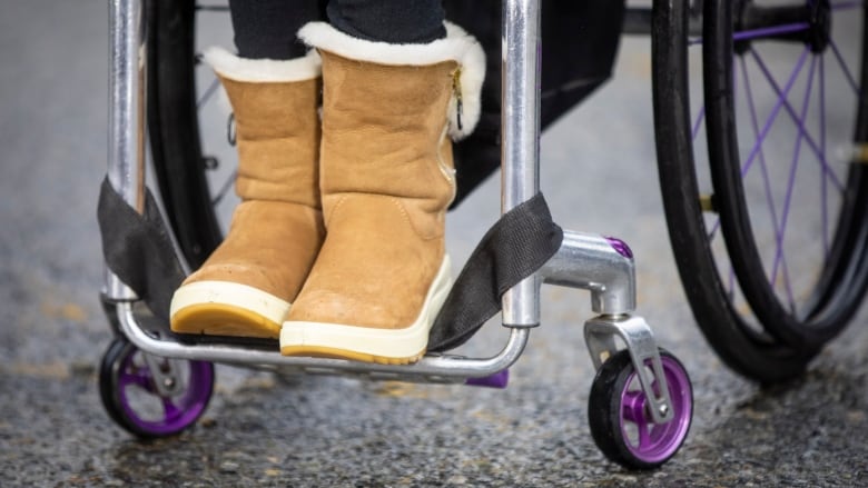 A woman is pictured in a wheelchair in Vancouver, British Columbia on Wednesday, February 1, 2023. The provincial government announced a new funding program to get more accessible taxis on the road.  