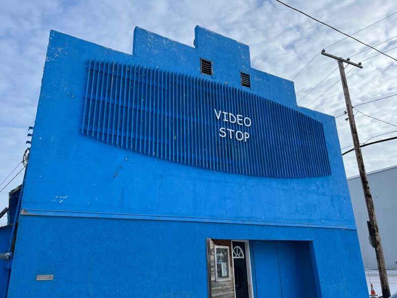 A large blue building with a sign that says Video Stop.