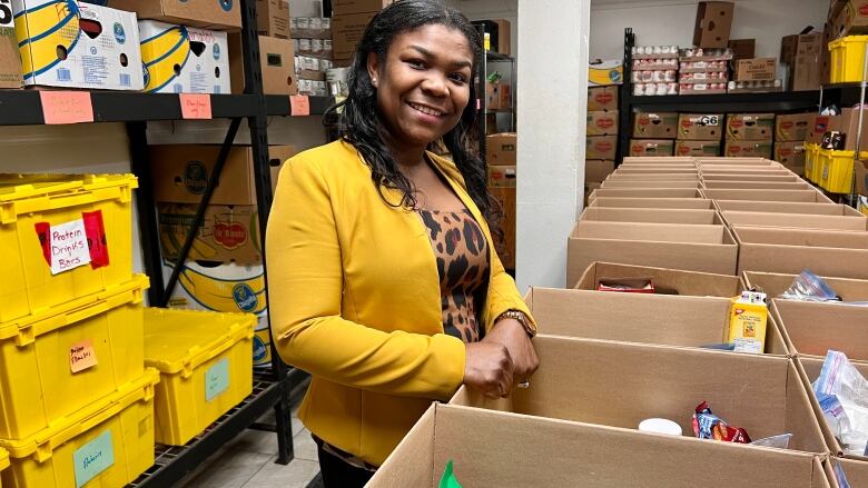 A woman packs boxes at a food bank