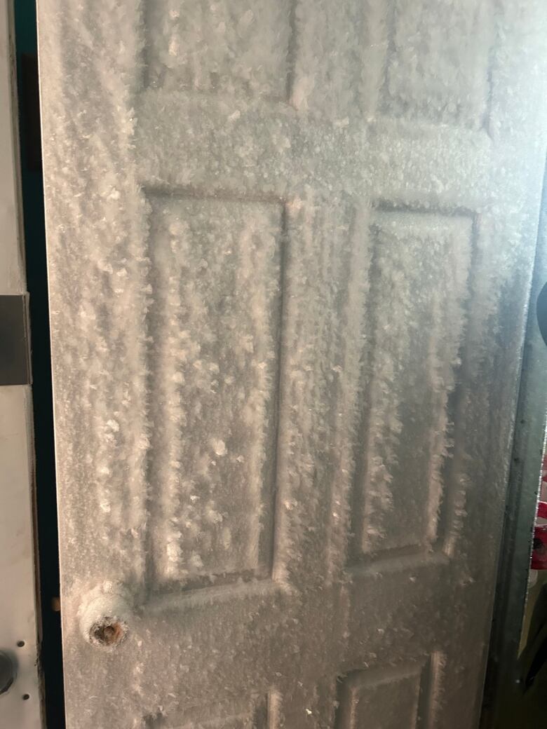 A frost covered door in a home. 