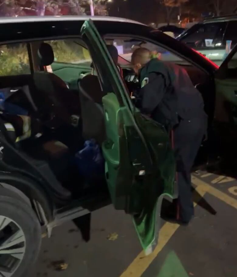 Halton police look through the stolen car behind a Petro-Canada gas station in Oakville.