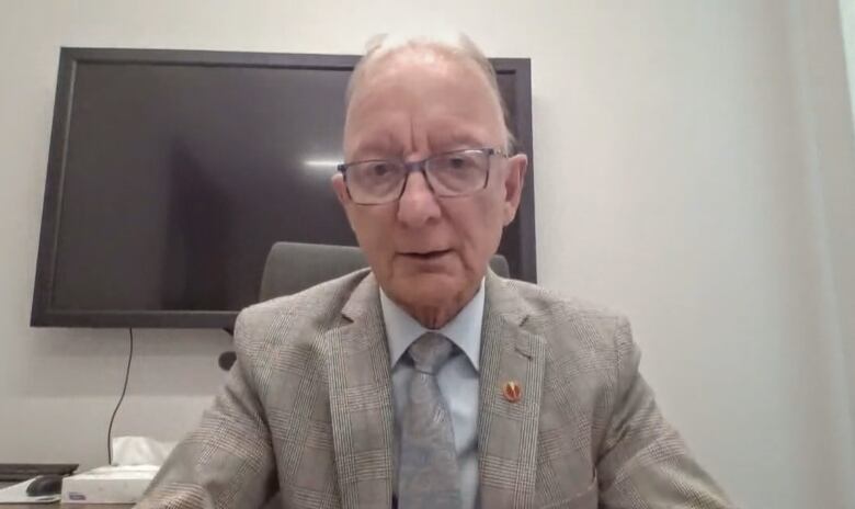 Senator Pierre-Hugues Boisvenu sits at a table in his office in Ottawa.