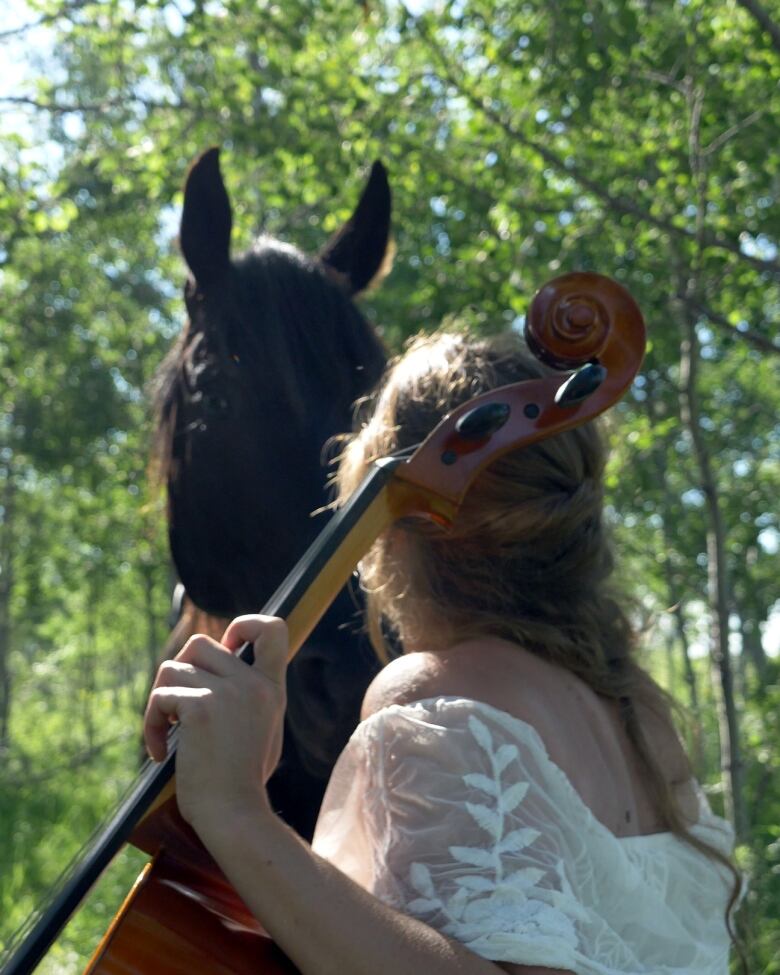 Jenalene Antony plays a cello in the forest in her short film for CBC's Creator Network. She says when she hears the music, she sees colour.