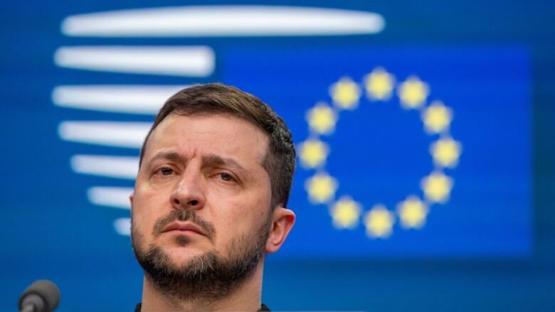 A man speaks into a microphone during a news conference.