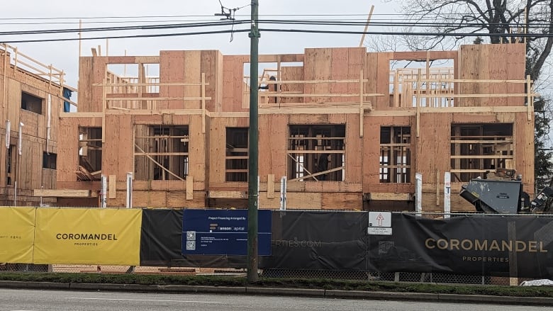 The skeleton of a building under construction showing its wood framing.