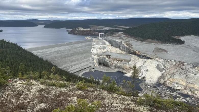 A large dam holds back water on a river