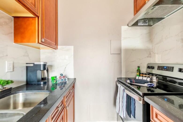 A clean kitchen with countertops, cupboards and appliances that look new.