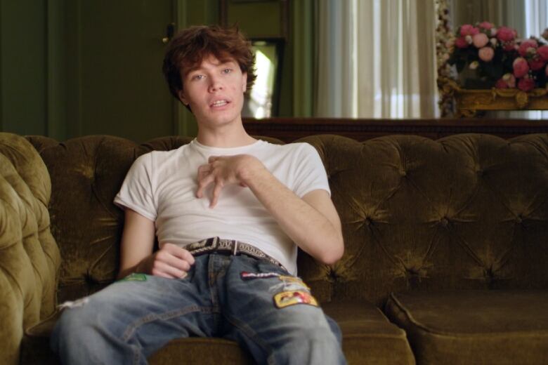 Young man in a white t-shirt and light blue jeans