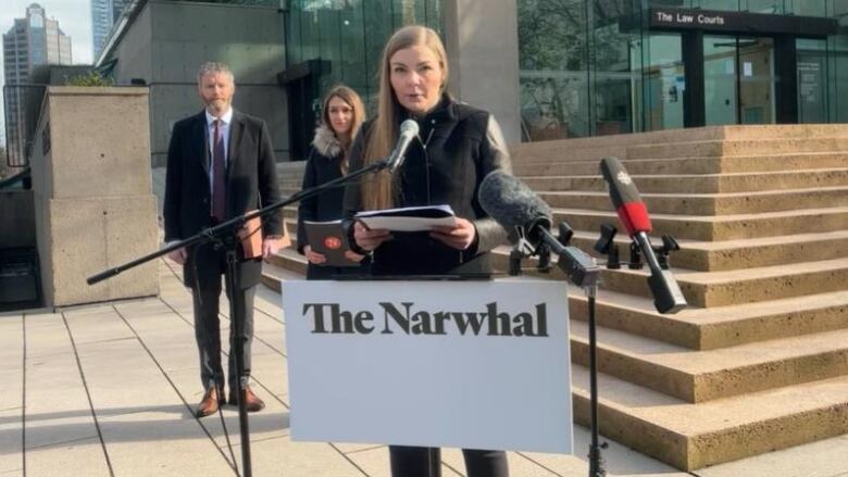 A woman stands at a podium.