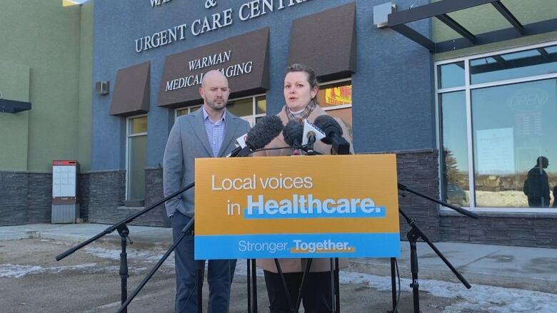 NDP health critic Vicki Mowat speaks to reporters in Warman as her colleague MLA Matt Love looks on. Mowat and Love called for the provincial government to restore Community Health Advisory Networks.