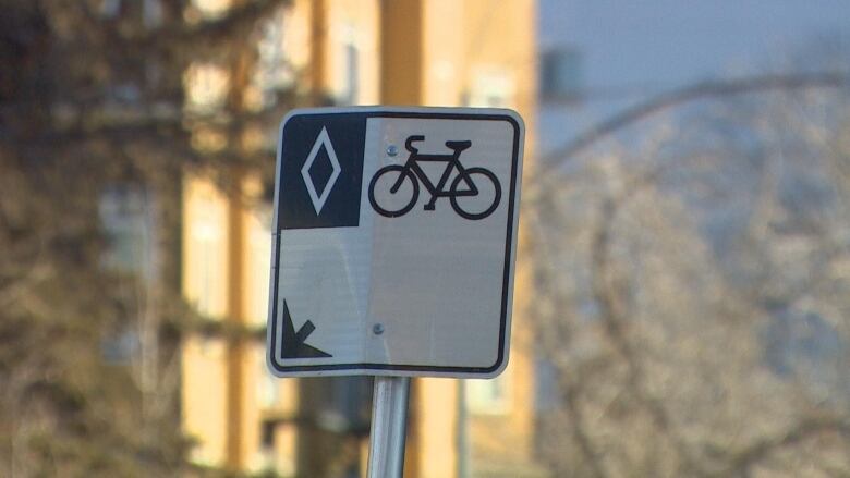 A sign indicates a bike lane on a Calgary street.