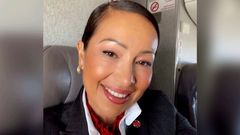 A woman takes a selfie on a plane.