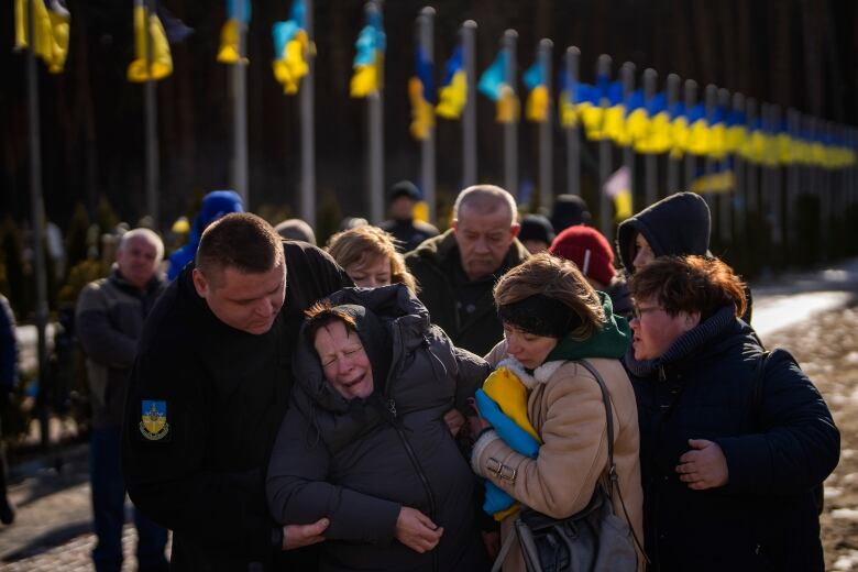 Valentyna Samoilenko reacts next to the body of her son Dmytro, 34, during his funeral in Irpin, near Kyiv, Ukraine on Tuesday, Feb. 14, 2023. Dmytro Samoilenko, a civilian who was a volunteer in the armed forces of Ukraine, was killed in the fighting in Bakhmut area.