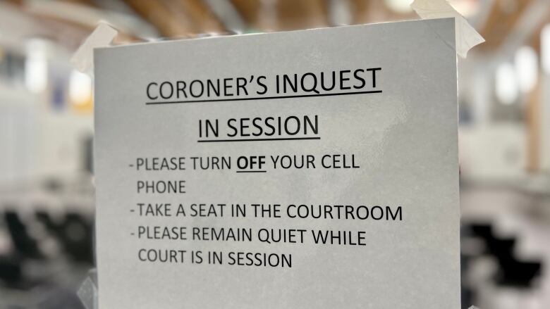 A sign on a door notifies people that an inquest is underway.