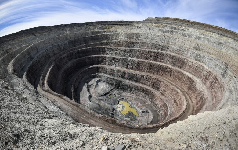 A large, deep diamond mine. Its circular with step-like layers.