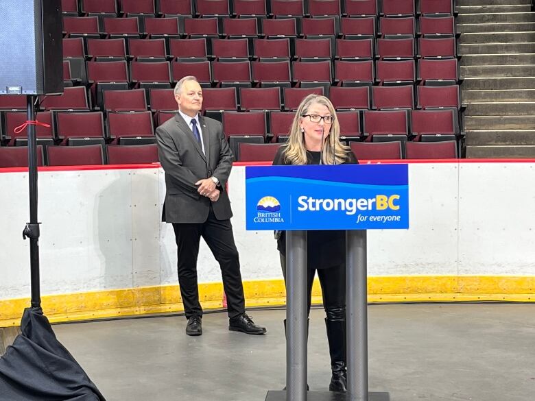 B.C.'s tourism minister stand behind a podium that reads 