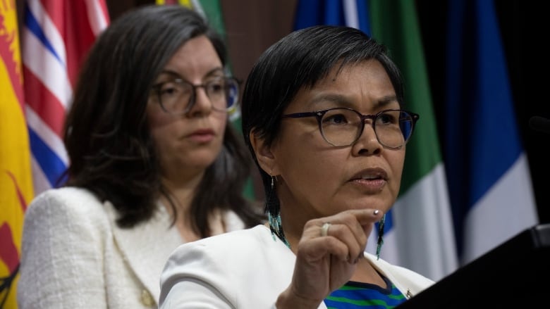 Lori Idlout speaks with Niki Ashton standing behind her.