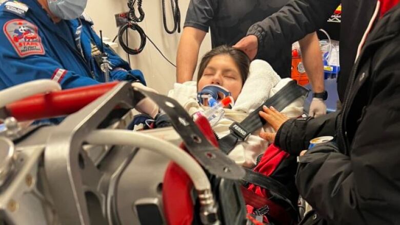 A teenager in a neck brace after a fire in northern Manitoba.