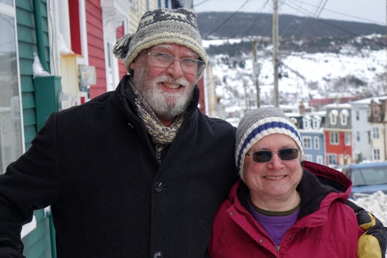 Michel Savard and Janet Kergoat stand outside their home in downtown St. John's on a winter day.