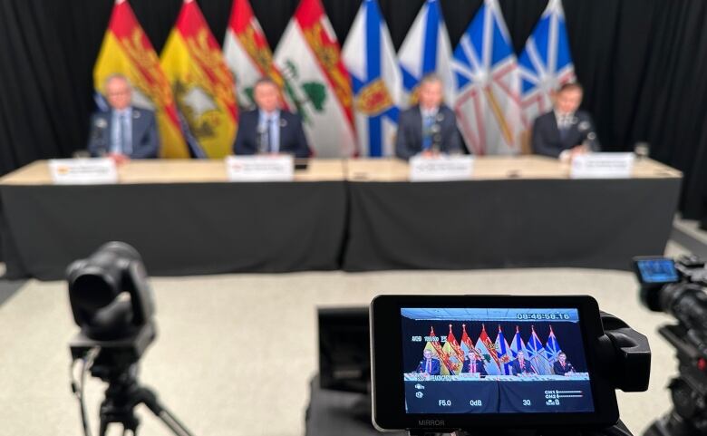 An image of the four premiers sitting at a table.