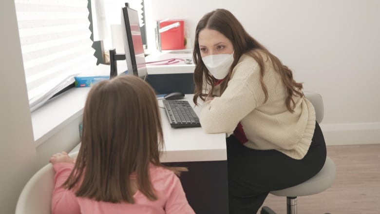 A nurse practitioner is pictured with a three-year-old girl.  