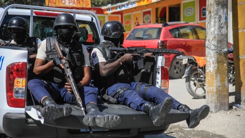 Police patrol Port-au-Prince, Haiti, on Jan. 31, 2023, after the funeral for three officers who were killed in the line of duty. The officers were killed in an ambush by gang members in the capital on Jan. 20.