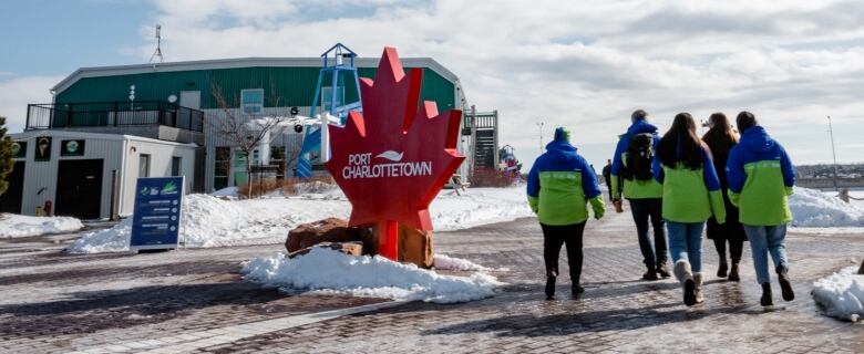 A group of Canada Games volunteers walk outside near the Port of Charlottetown