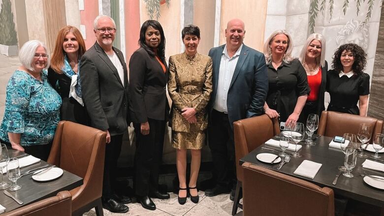 People pose in a restaurant.