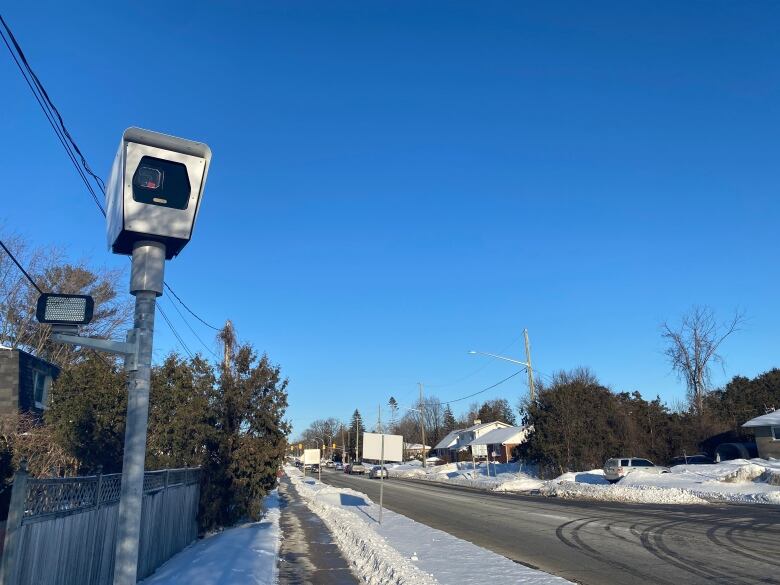 A speed camera on the side of the road. 