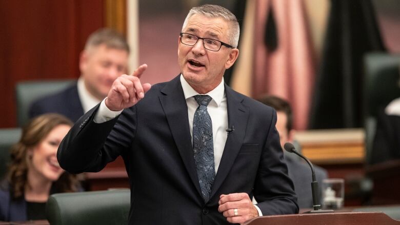 Alberta Finance Minister Travis Toews gestures with his right hand as he delivers the 2023 budget, in Edmonton on Tuesday, February 28, 2023.