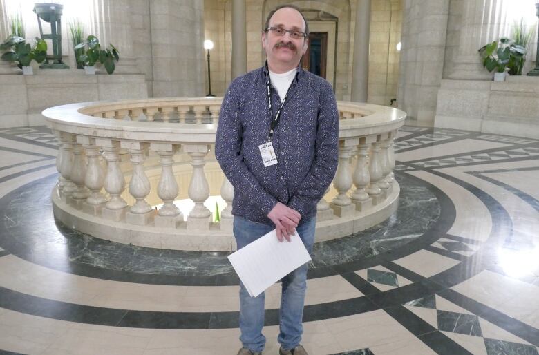 A man standing in the rotunda of the Manitoba Legislative Building.