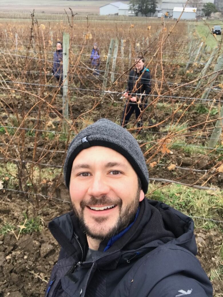 Team of people in vineyard in winter. 