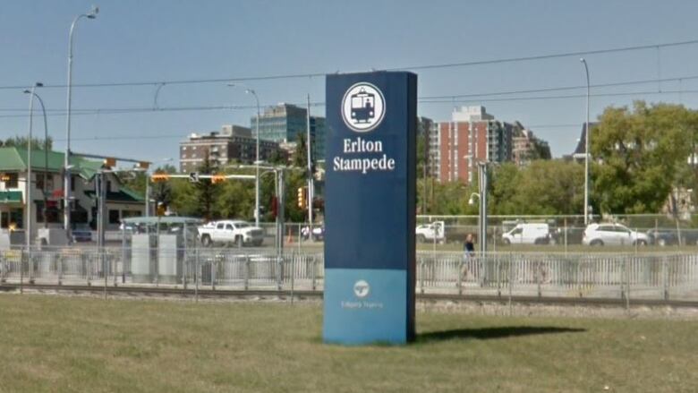 A sign indicates the Erlton/Stampede LRT stop in southeast Calgary adjacent to the train tracks.