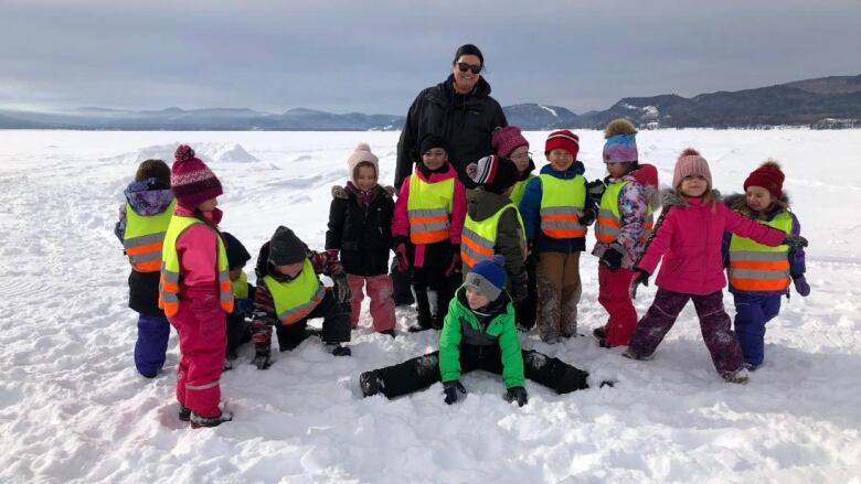 Brenda Germain stands above her gaggle of kindergarten students on the ice.