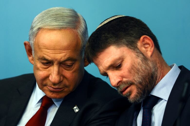 Israeli Prime Minister Benjamin Netanyahu speaks with his Finance Minister Bezalel Smotrich. 