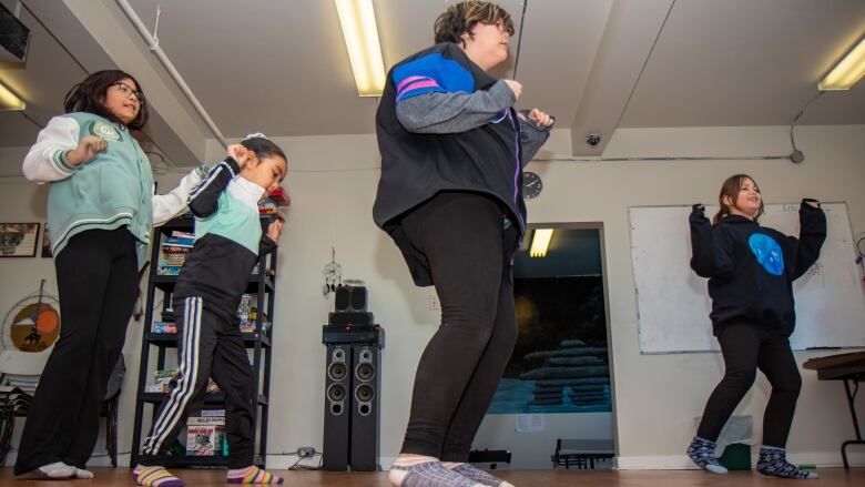 Kids dance to a Zumba workout.