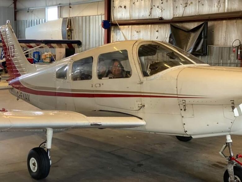 Zack's Grandmother Louise sits in the cockpit of the aircraft.