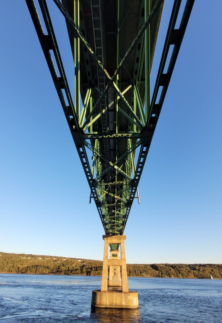 The view of the Seal Island Bridge from below the superstructure. It is sunny and the water is calm.