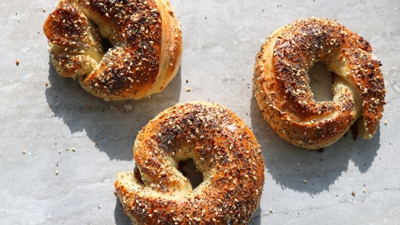 Bagels sit on a counter.