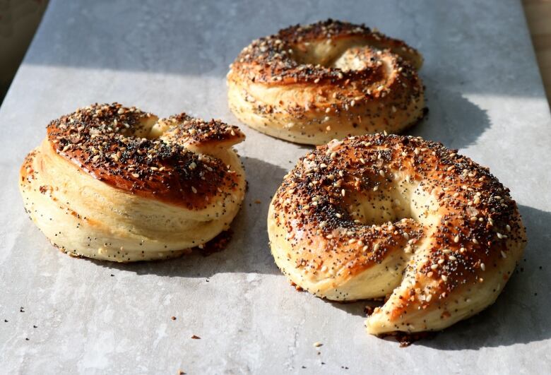 Bagels sit on a counter.