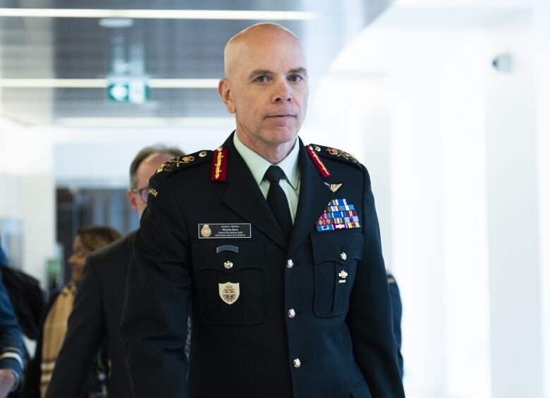 A military official walks down a hall.