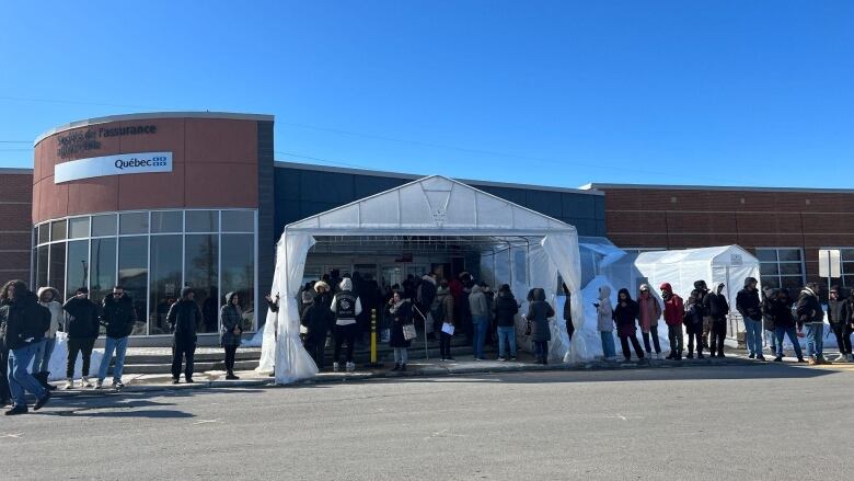 Customers line up outside a SAAQ service centre. 