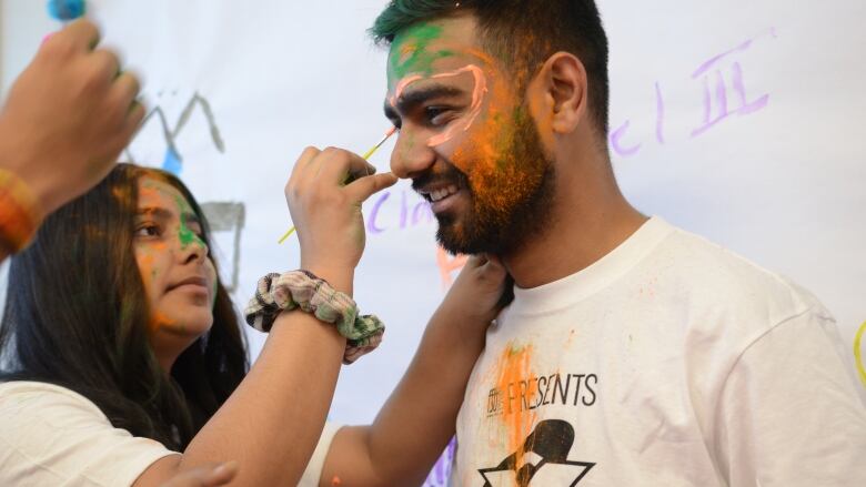 girl paints boys face