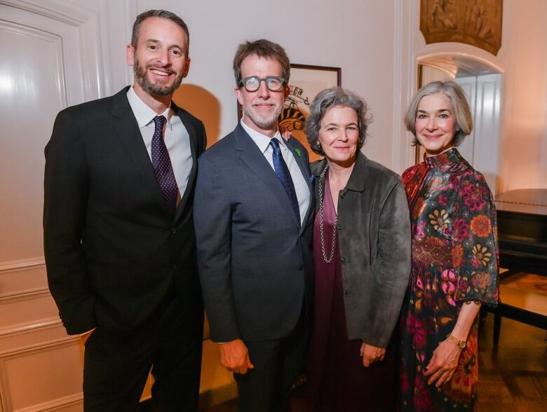 Two men and two women pose for a photo.