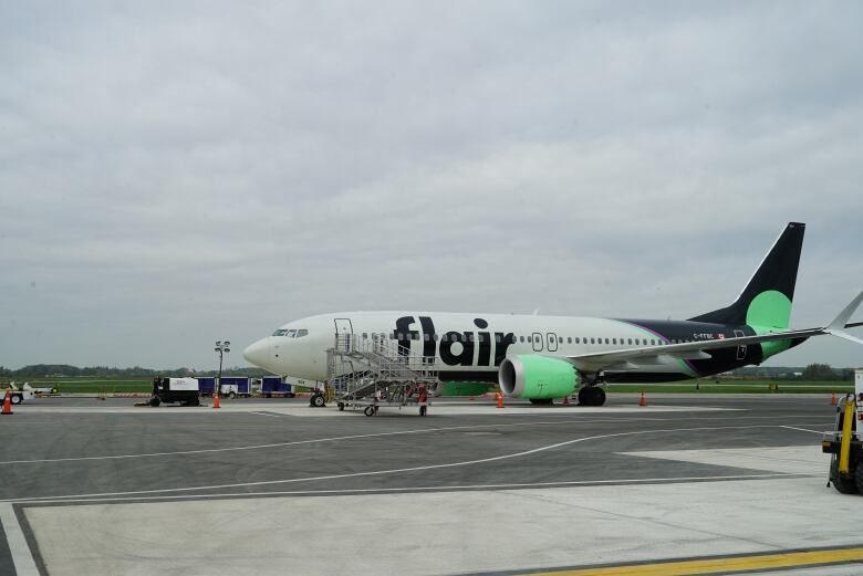 A plane is seen parked on a runway.