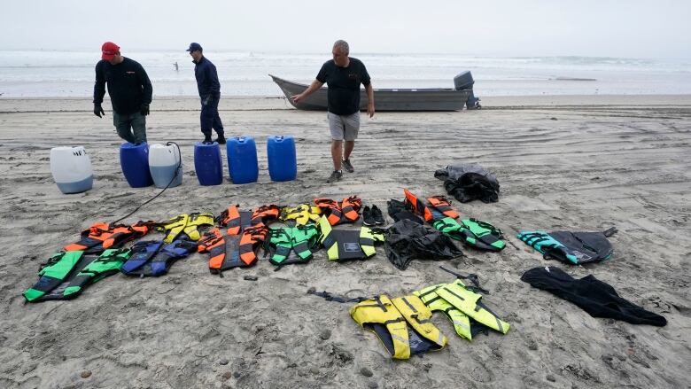 A boat salvager works on the beach in California.