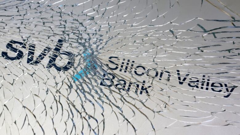 SVB (Silicon Valley Bank) logo is seen through broken glass in this illustration taken March 10, 2023.