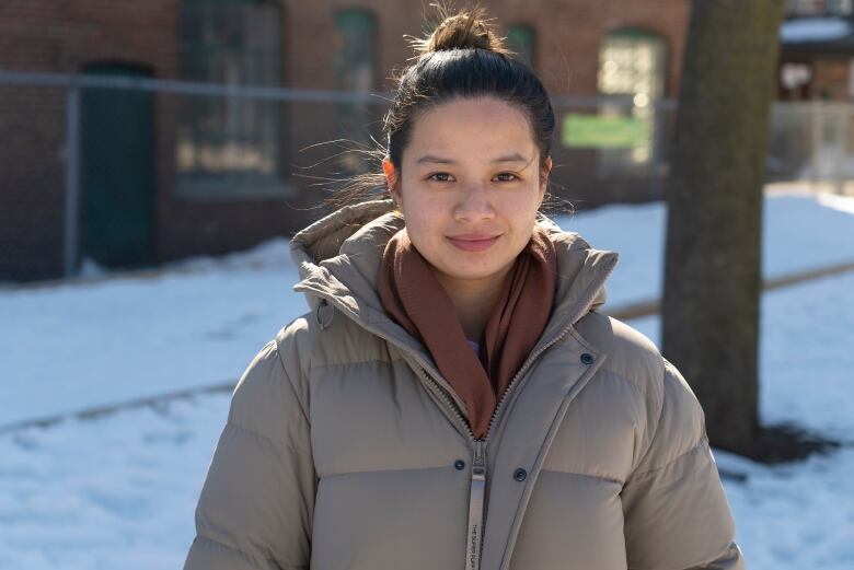 Portrait of of a woman outside in a playground in winter.